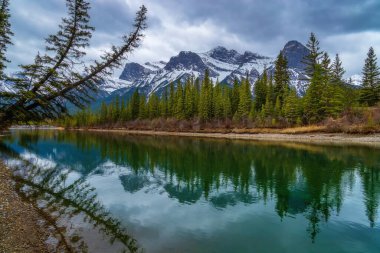 Panoramic View Of Canmore Mountains And River On A Moody Day