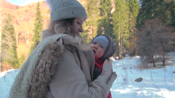 Mother carry her infant son in a bay carrier during mountain hiking — Video Stock