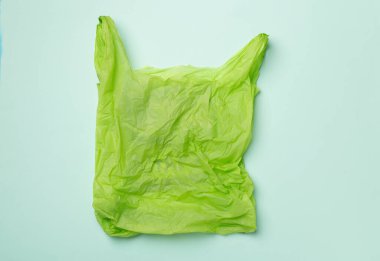 Disposable plastic bag on color background, top view.