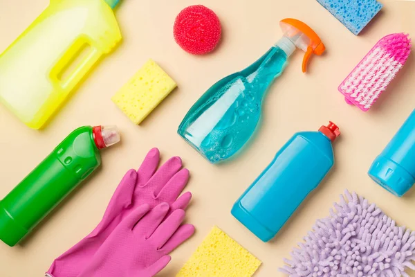 Many different house cleaning products on color background, top view.