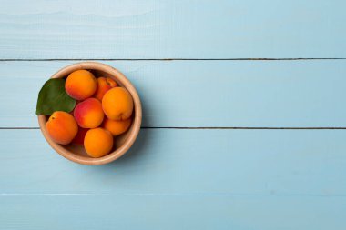 Composition with ripe apricots on wooden background, top view.