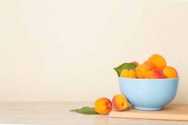 Composition with ripe apricots on wooden table.