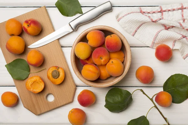 Composition with ripe apricots on wooden background, top view.