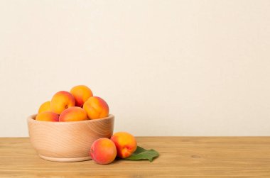 Composition with ripe apricots on wooden table.