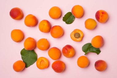 Flat lay with ripe ap.ricots on color background, top view.