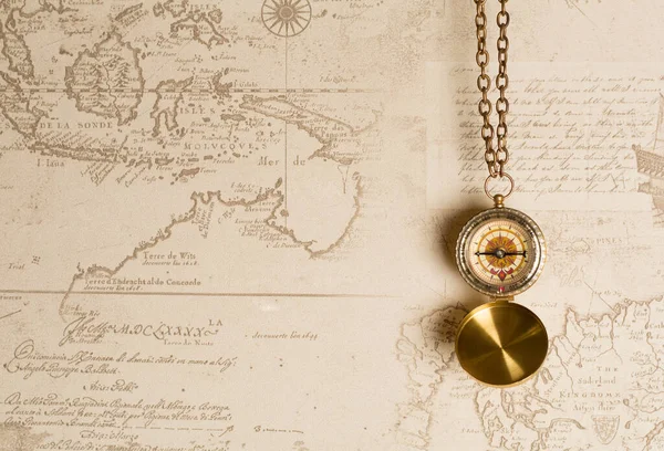 Old vintage compass on map background.