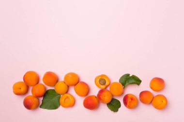 Flat lay with ripe ap.ricots on color background, top view.