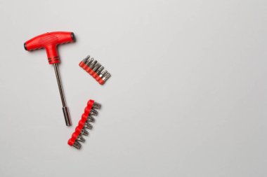 Screwdriver bit set on color background, top view.