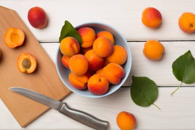 Composition with ripe apricots on wooden background, top view.
