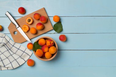 Composition with ripe apricots on wooden background, top view.