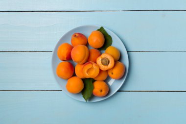 Composition with ripe apricots on wooden background, top view.