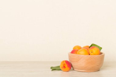 Composition with ripe apricots on wooden table.
