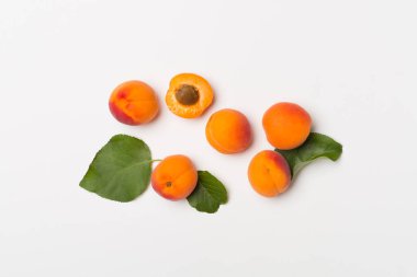 Flat lay with ripe apricots on white background, top view.