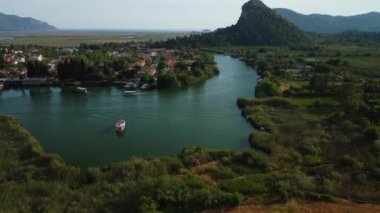 Isolated boat on the Dalyan river in the town of Dalyan - Turkey - aerial view.