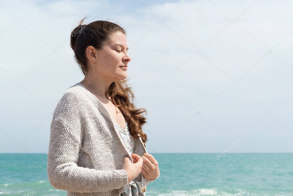 Happy woman enjoying the fresh air from the sea.
