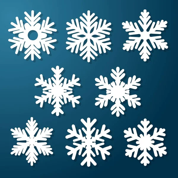 Mavi Noel arka planında beyaz kesilmiş kar taneleri vektörü ayarlandı — Stok Vektör