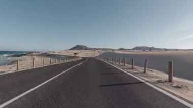 Pov car driving through Corralejo Sand Dunes natural park in Fuerteventura, Canary Islands