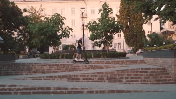 Man White Cap Riding Electric Scooter City — ストック動画