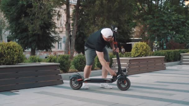 Man White Cap Riding Electric Scooter City — Video