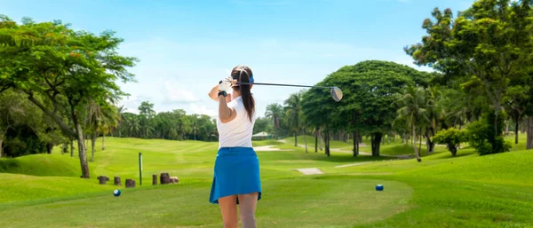 Golfer sport course golf ball fairway. People lifestyle woman playing game golf tee of blue sky background. Asia female player game shot in summer. copy space for banner