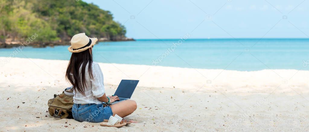 Lifestyle freelance woman using laptop working and relax on the beach. Asian people success and together your work pastime and meeting conference on internet in holiday