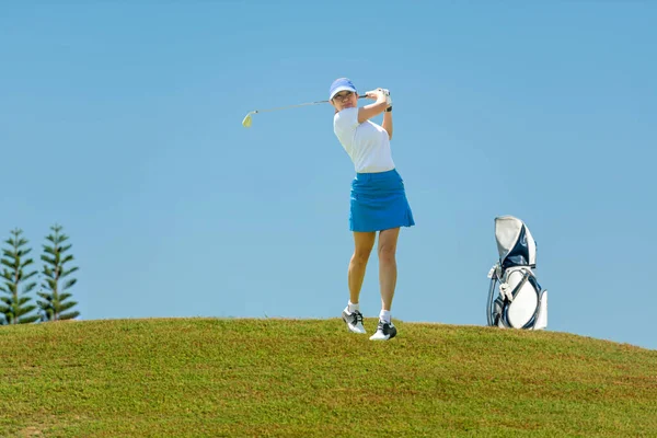 Golfer sport course golf ball fairway. People lifestyle woman playing game golf tee of blue sky background. Asia female player game shot in summer. Healthy and Sport outdoor