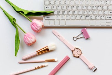 Makeup beauty cosmetic fashion in office. Cosmetics woman working on laptop with bag product facial and coffee on white background. Lifestyle fashion Gift Concept, top view
