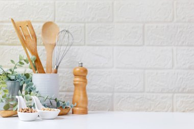 Select focus. Kitchen tools and kitchenware utensil object on kitchen shelf wood white for healthy eat and health care life.  Wall white brick background, copy space for text