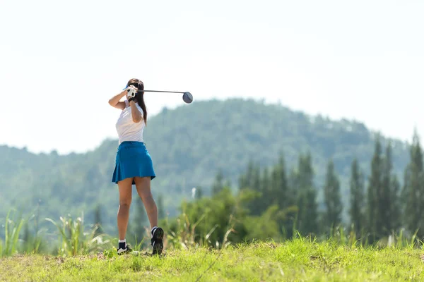 Golfer sport course golf ball fairway. People lifestyle woman playing game golf tee of mountain background. Asia female player game shot in summer. Healthy and Sport outdoor