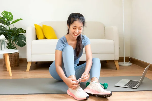 Healthy lifestyle young woman fitness gym for body slim. Young people girl exercise at living room on line. Fitness instructor exercising the fitness. Diet and Healthy sport Concept