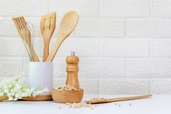 Kitchen tools and kitchenware utensil object on kitchen shelf wood white for healthy eat and health care life.  Wall white brick background, copy space for text