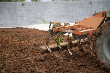 Traktör toprağı sürüp, bahçeyi yaza hazırlıyor. 
