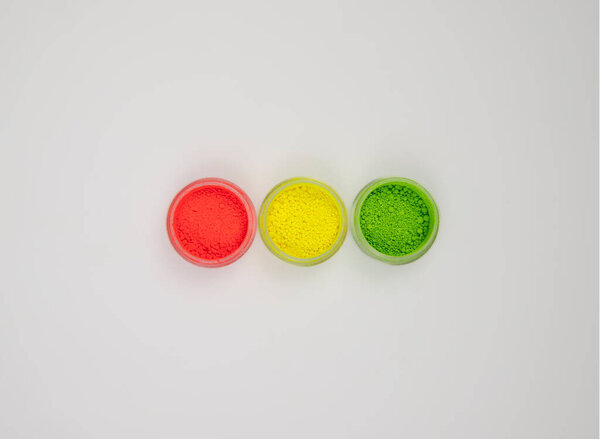 set of three colors of neon colored acrylic powders simulating a