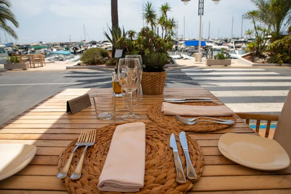 Reserved restaurant table in the port, laid table, with a view o