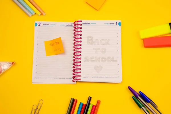 Diary September 1, back to school, goodbye to summer, with a yellow background accompanied by materials for class