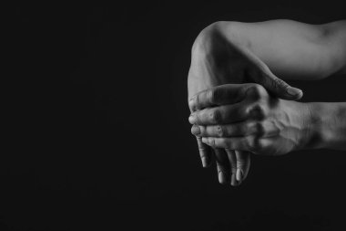 close-up hand massage on a dark background