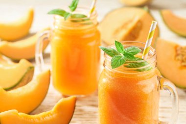 Kavun püresi cam kavanozlarda ve nane arkaplanlı taze kavun. Sağlıklı beslenme kavramı..