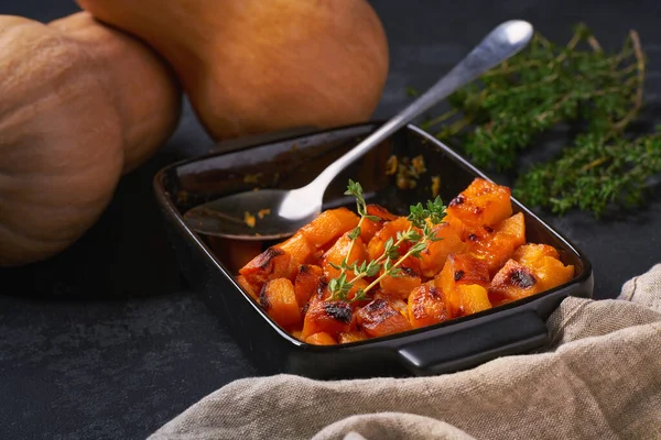 Baked Butternut Squash Cubes Thyme Ceramic Bowl Black Stone Table — 스톡 사진