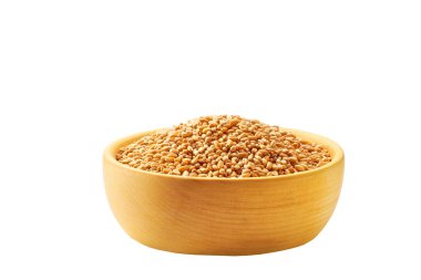 dry wheat grains in a wooden bowl isolated on white background.