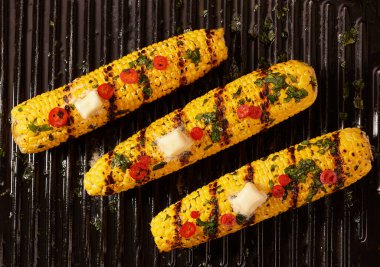 Homemade grilled corn cob with melting butter, top view. Corn grilled with butter .