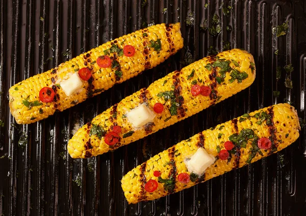 Homemade grilled corn cob with melting butter, top view. Corn grilled with butter .