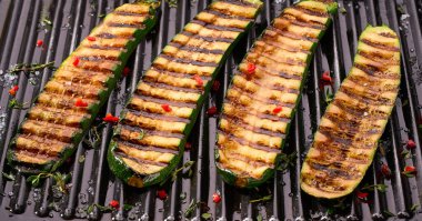 Sliced grilled zucchini with chilli pepper and spices, top view. Ideas for barbecues and grill parties.