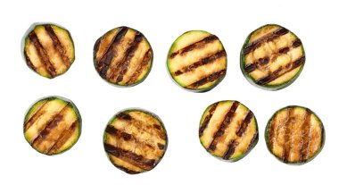 Grilled zucchini slices isolated on white background, top view