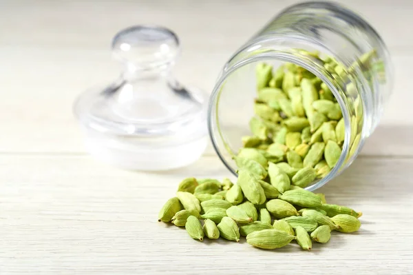 Green Cardamom Pods Spill Out Glass Storage Jar White Wooden — Stock Photo, Image