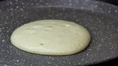 Sıcak tavada krep pişirmek. Kadın eli, spatula kullanırken sıcak tavada krep pişirirken aile kahvaltısı için ev yapımı gözleme yaparken yakın plan bir fotoğraf..