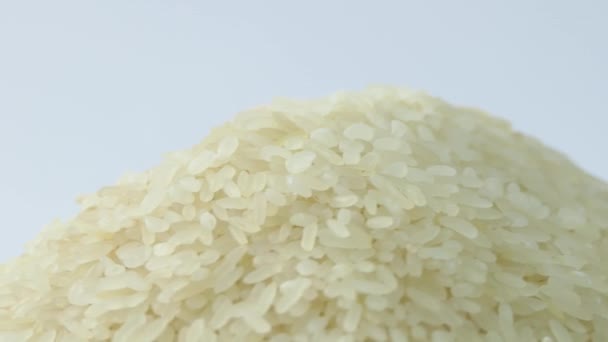 Macro white raw rice texture, food background, vegetarian healthy eating product. Rotating close up of a pile of raw rice — Video Stock