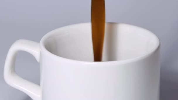 Pouring black coffee into a white cup. Top view of coffee poured into a cup with foam. — Video Stock