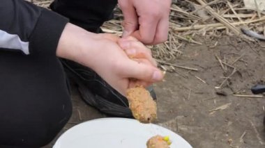 Fisherman loads the bait in the feeder tackle for fishing. Spring fishing.