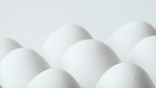 Eggs in a carton, spinning white chicken eggs in a carton. Chicken white fresh raw eggs in egg container — Vídeo de Stock
