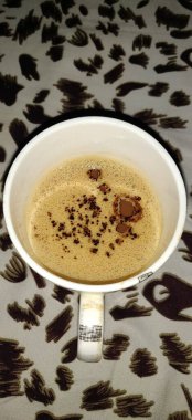 Zarif bir fincan taze demlenmiş kahve ve şık dokuma minder - Kafeler ve kahve aşıkları için mükemmel